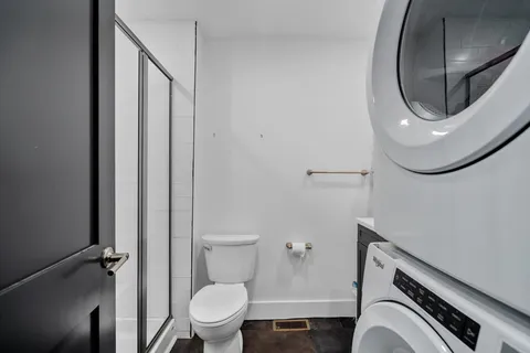 a bathroom with a toilet and a mirror