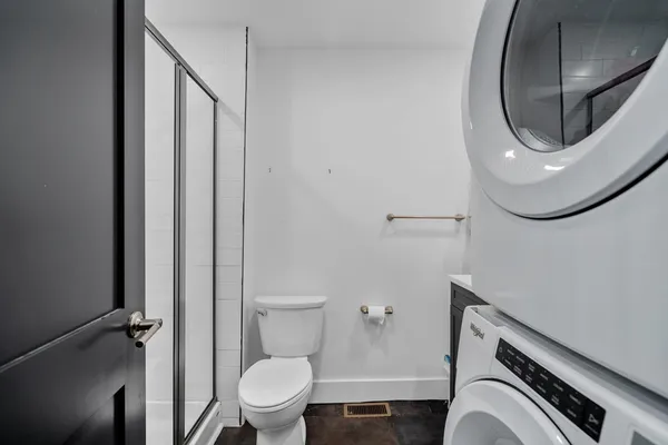 a bathroom with a toilet and a mirror