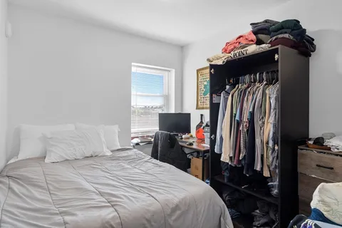 a bedroom with a bed and a closet