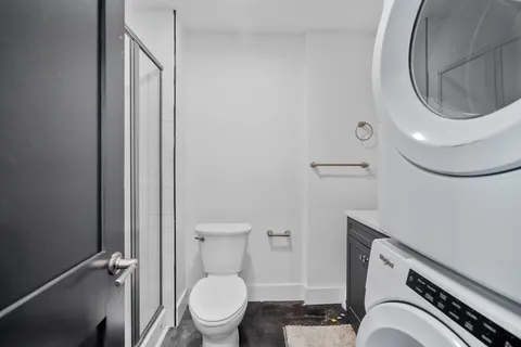 a bathroom with a toilet a sink and a mirror