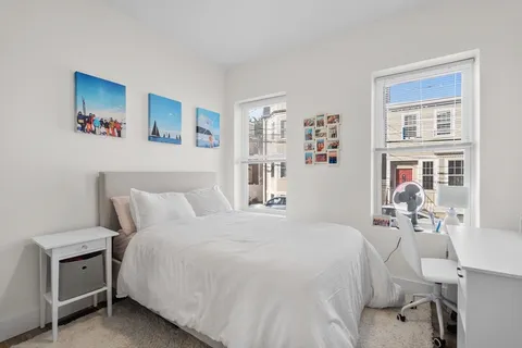 a bedroom with a bed and a table