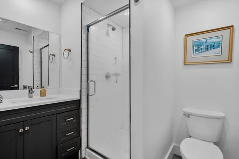 a bathroom with a toilet sink shower and mirror