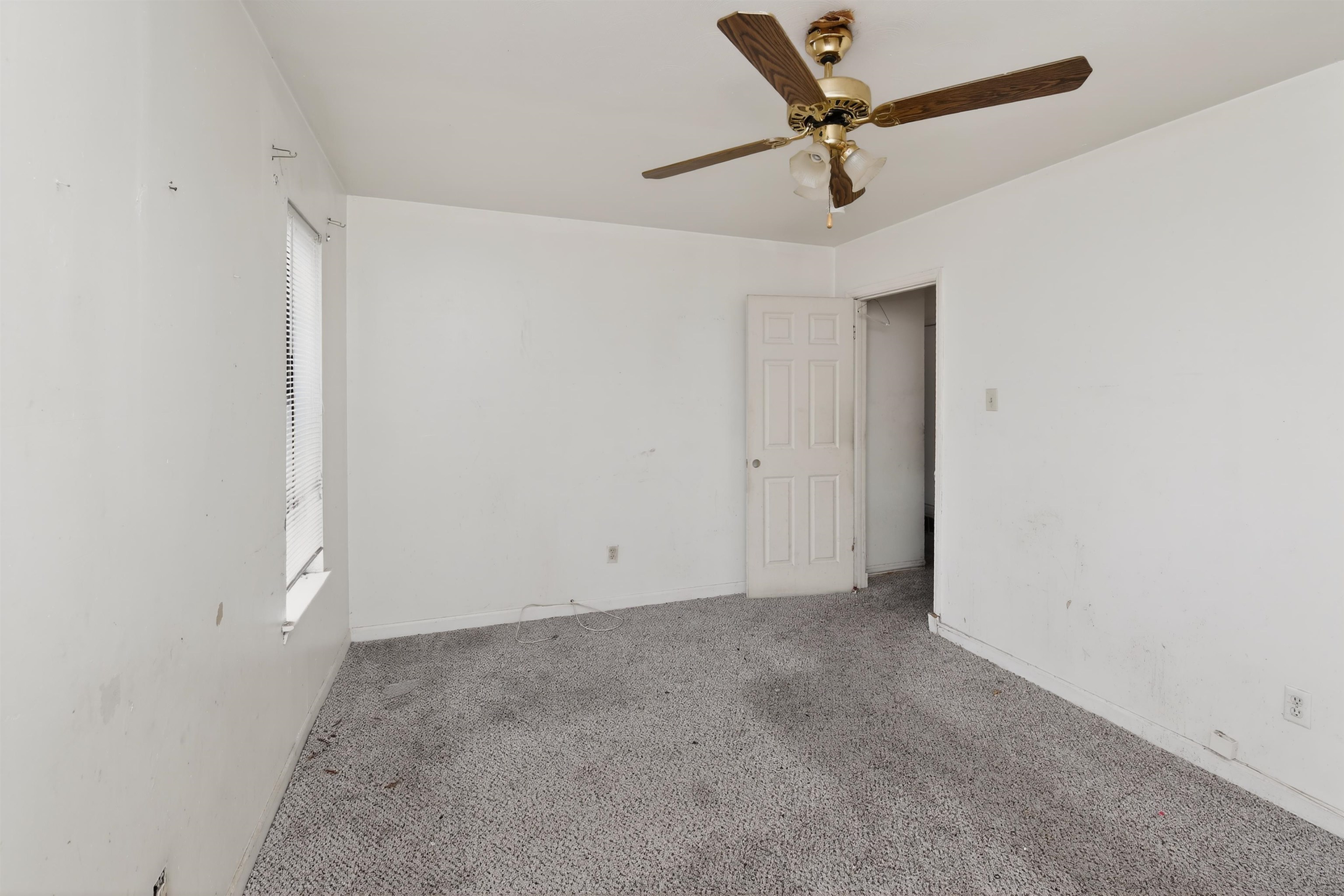 3451 Birdsong Ferry Road Memphis, TN 38118 - Photo 11 of 27 Carpeted room featuring a ceiling fan with integrated lighting, a window with blinds, and a paneled interior door