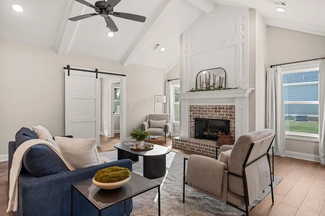 a living room with furniture and a fireplace