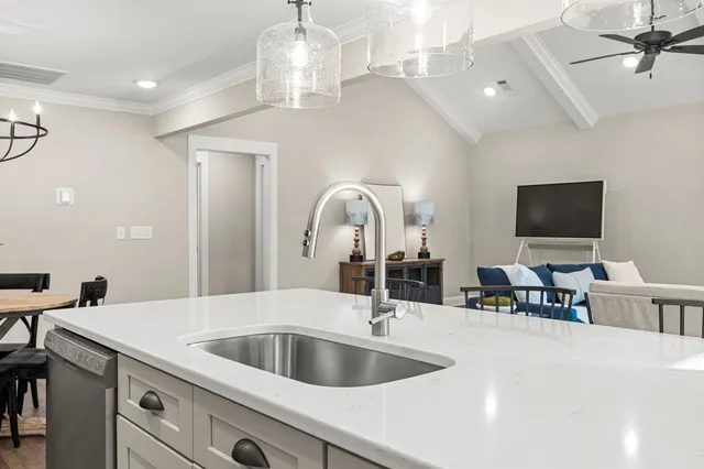 a close view of a sink and a large mirror in a room