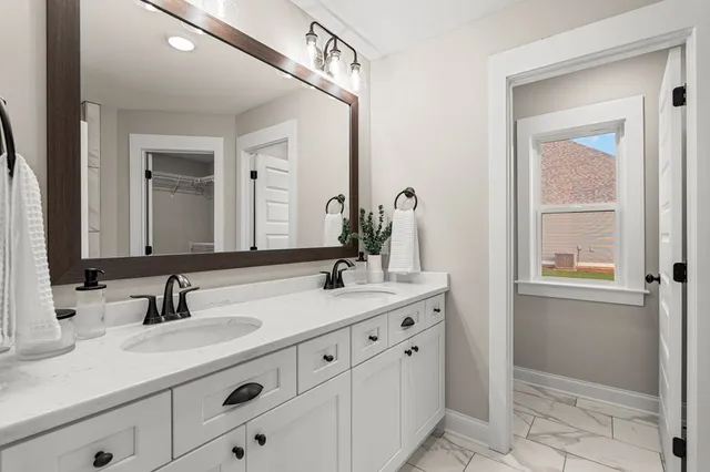 a bathroom with double sink and a mirror