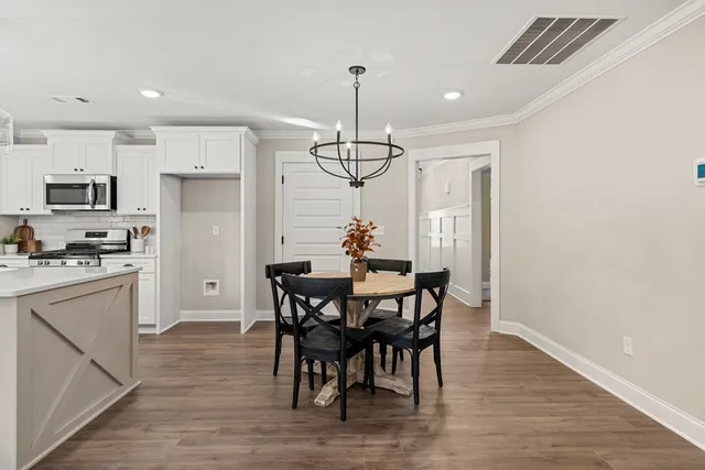 a view of a dining room with furniture window and wooden floor