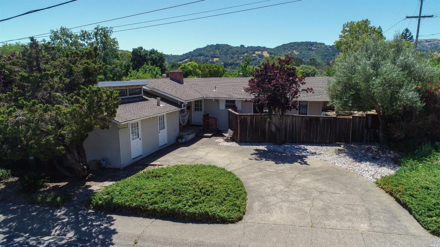585 Las Colindas Road San Rafael, CA 94903 - Photo 1 of 1 a view of a backyard with a trees and wooden fence