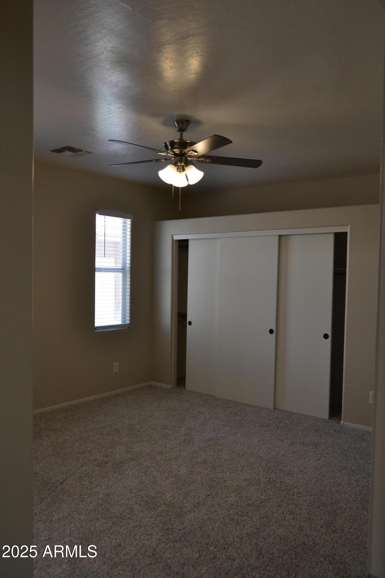 2300 East Magma Road, Unit 77 San Tan Valley, AZ 85143 - Photo 11 of 12 a view of a room with a ceiling fan and a window