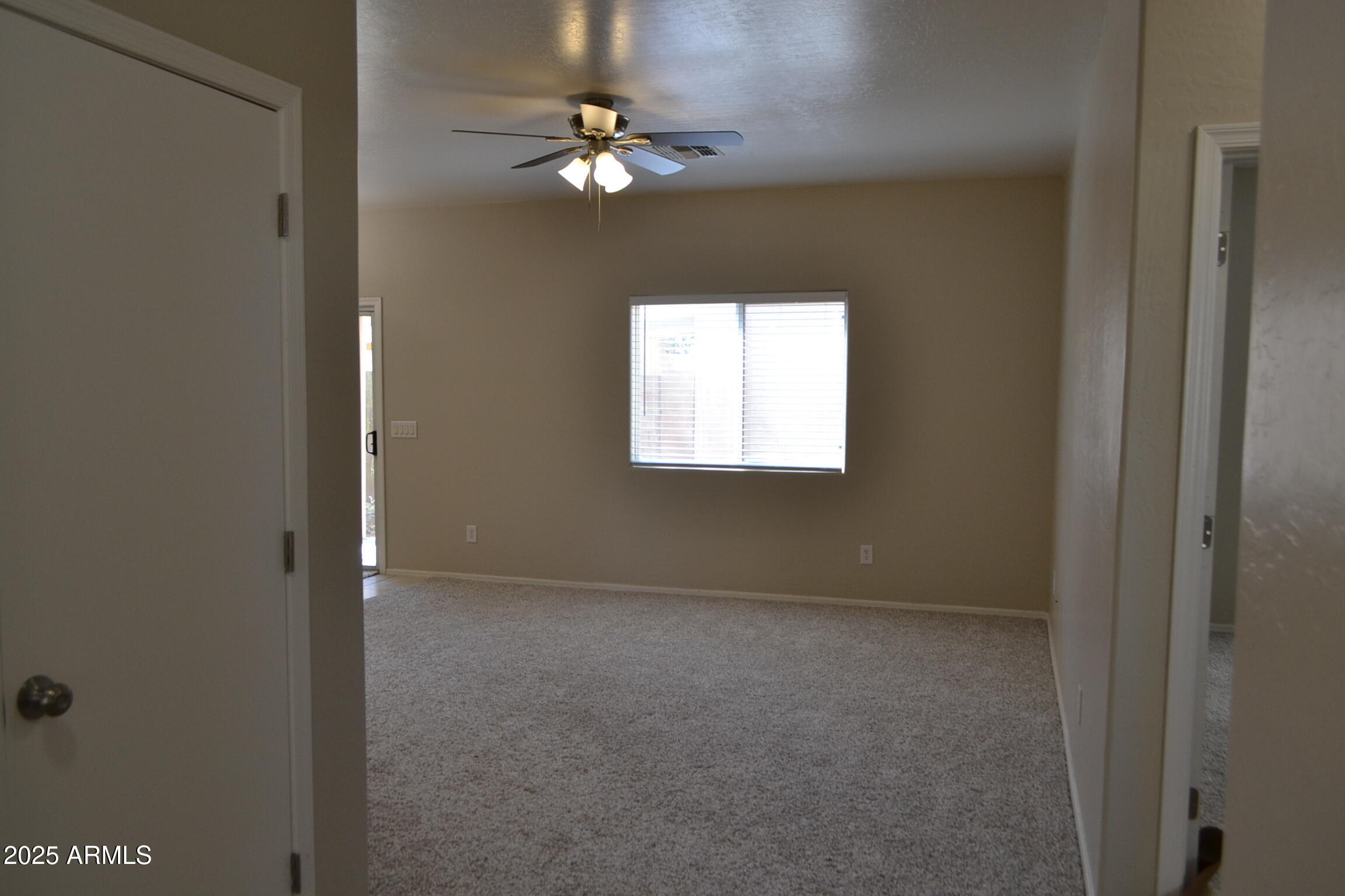 2300 East Magma Road, Unit 77 San Tan Valley, AZ 85143 - Photo 3 of 12 an empty room with windows and fan