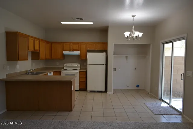 a kitchen with a refrigerator and a sink