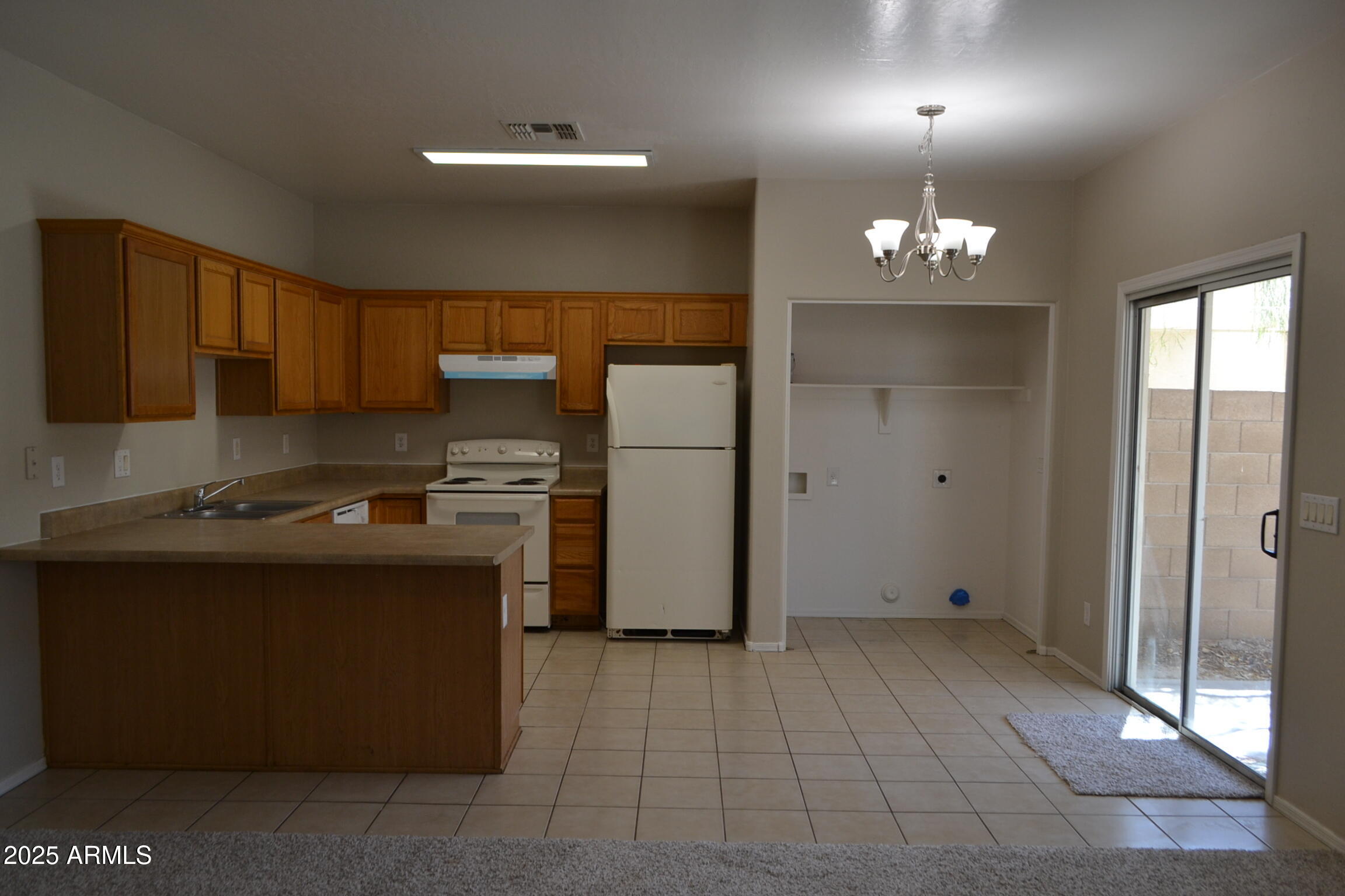 2300 East Magma Road, Unit 77 San Tan Valley, AZ 85143 - Photo 5 of 12 a kitchen with a refrigerator and a sink