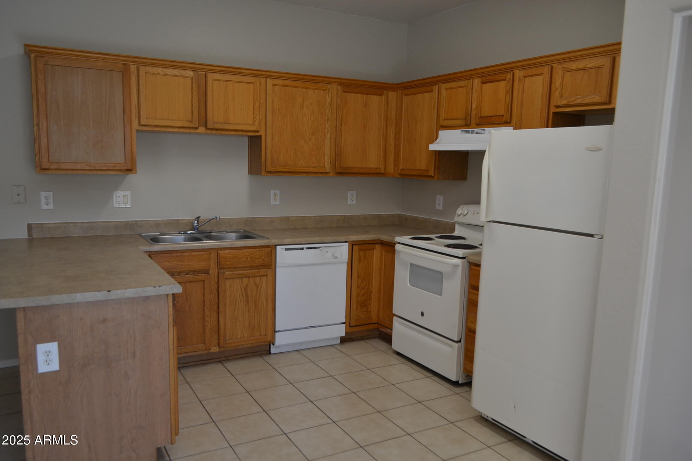 2300 East Magma Road, Unit 77 San Tan Valley, AZ 85143 - Photo 6 of 12 a kitchen with a sink a stove and cabinets