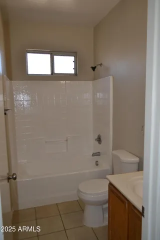 a bathroom with a shower a toilet and a sink