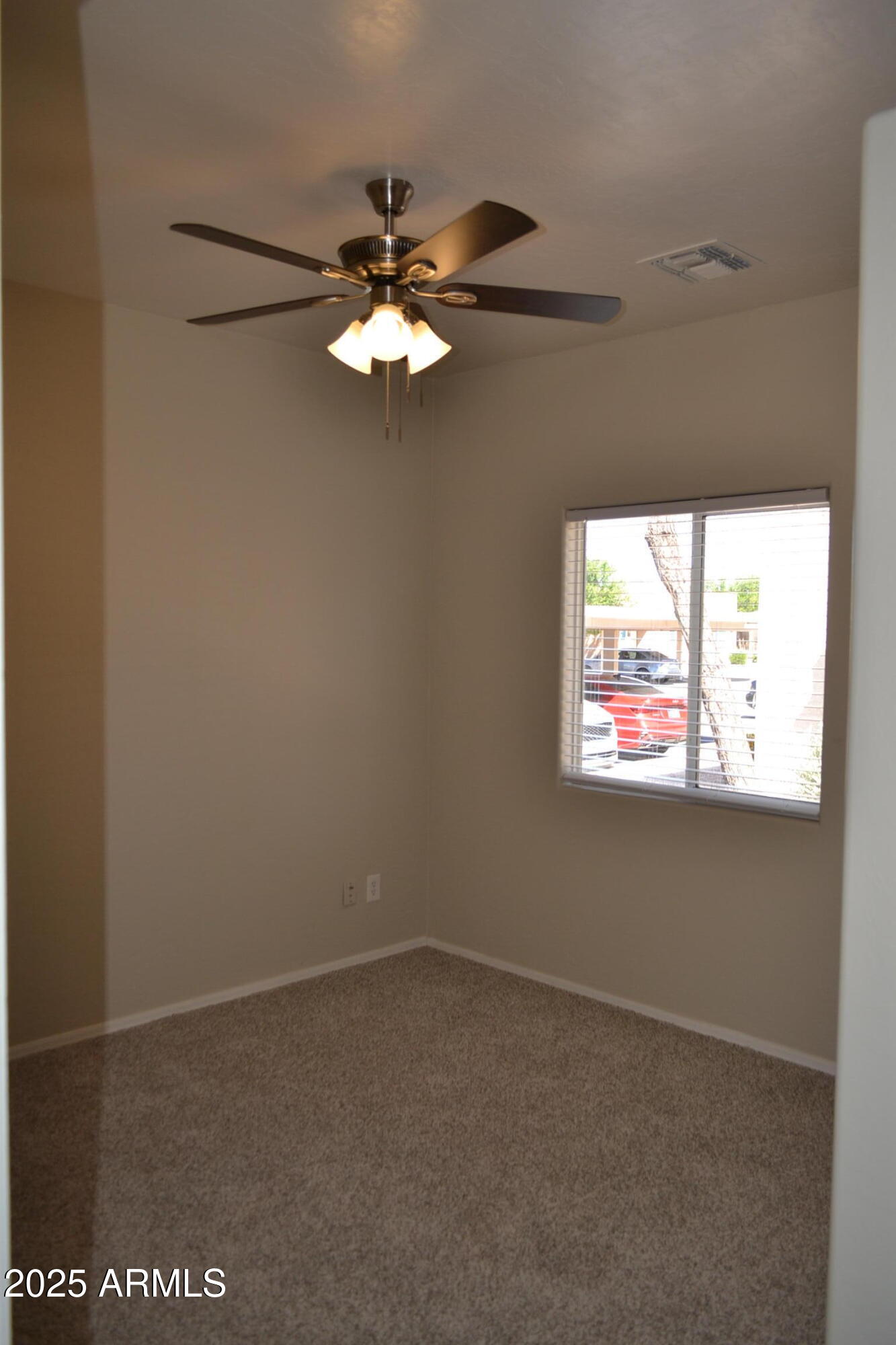 2300 East Magma Road, Unit 77 San Tan Valley, AZ 85143 - Photo 10 of 12 an empty room with windows and fan