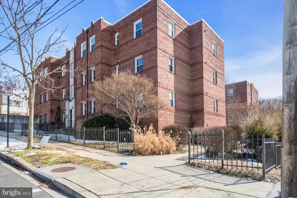 a view of a building with a snow on the road