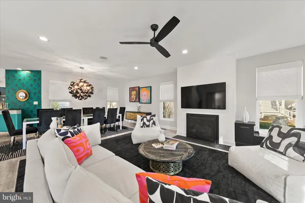 a living room with furniture kitchen view and a fireplace