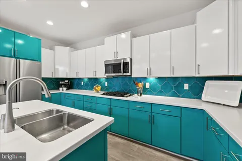 a kitchen with cabinets a sink and a stove top oven
