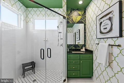 a bathroom with a sink a mirror and a shower