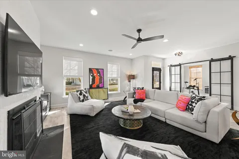 a living room with furniture kitchen view and a fireplace