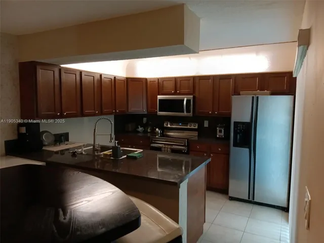 a kitchen with a sink appliances and cabinets