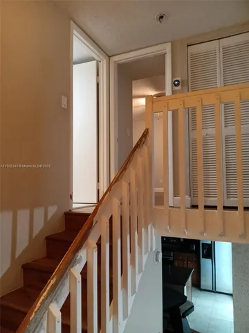a view of entryway with wooden floor and stairs
