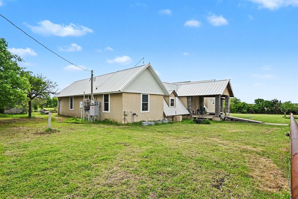 6694 Hutcheson Hill Road Springtown, TX 76082 - Photo 1 of 37 a view of a house with a big yard plants and large tree