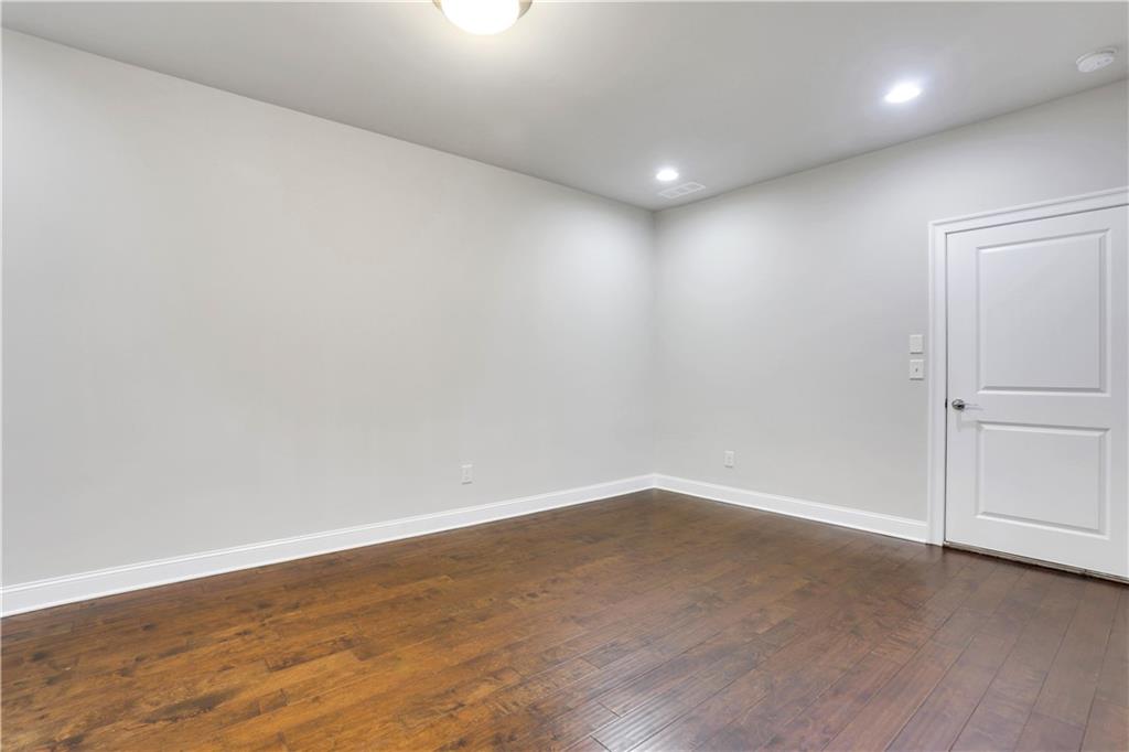 4103 Township Parkway Atlanta, GA 30342 - Photo 22 of 42 an empty room with wooden floor and white walls
