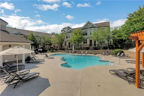 a swimming pool with outdoor seating yard and barbeque oven