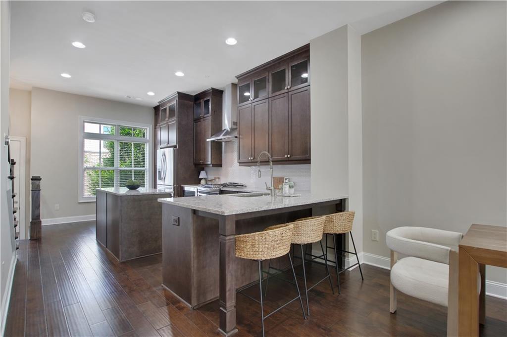 4103 Township Parkway Atlanta, GA 30342 - Photo 4 of 42 a kitchen with kitchen island stainless steel appliances a table and chairs in it