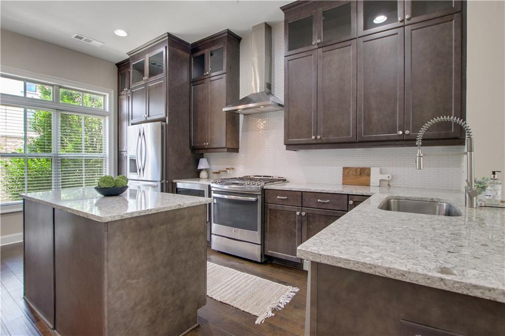 4103 Township Parkway Atlanta, GA 30342 - Photo 5 of 42 a kitchen with stainless steel appliances granite countertop a sink stove and refrigerator