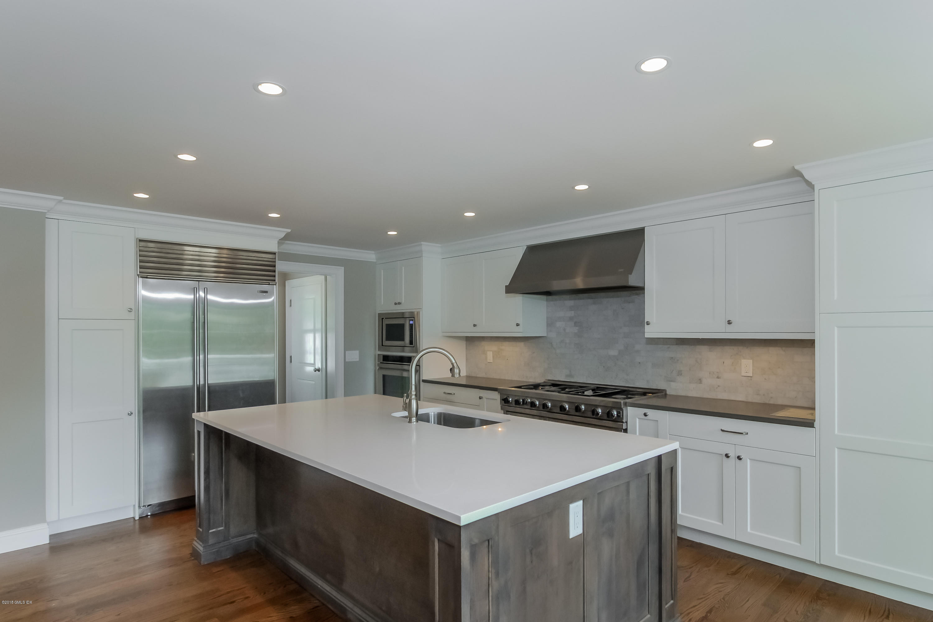 6 Dialstone Lane Riverside, CT 06878 - Photo 7 of 24 a kitchen with a sink a counter top space cabinets and stainless steel appliances