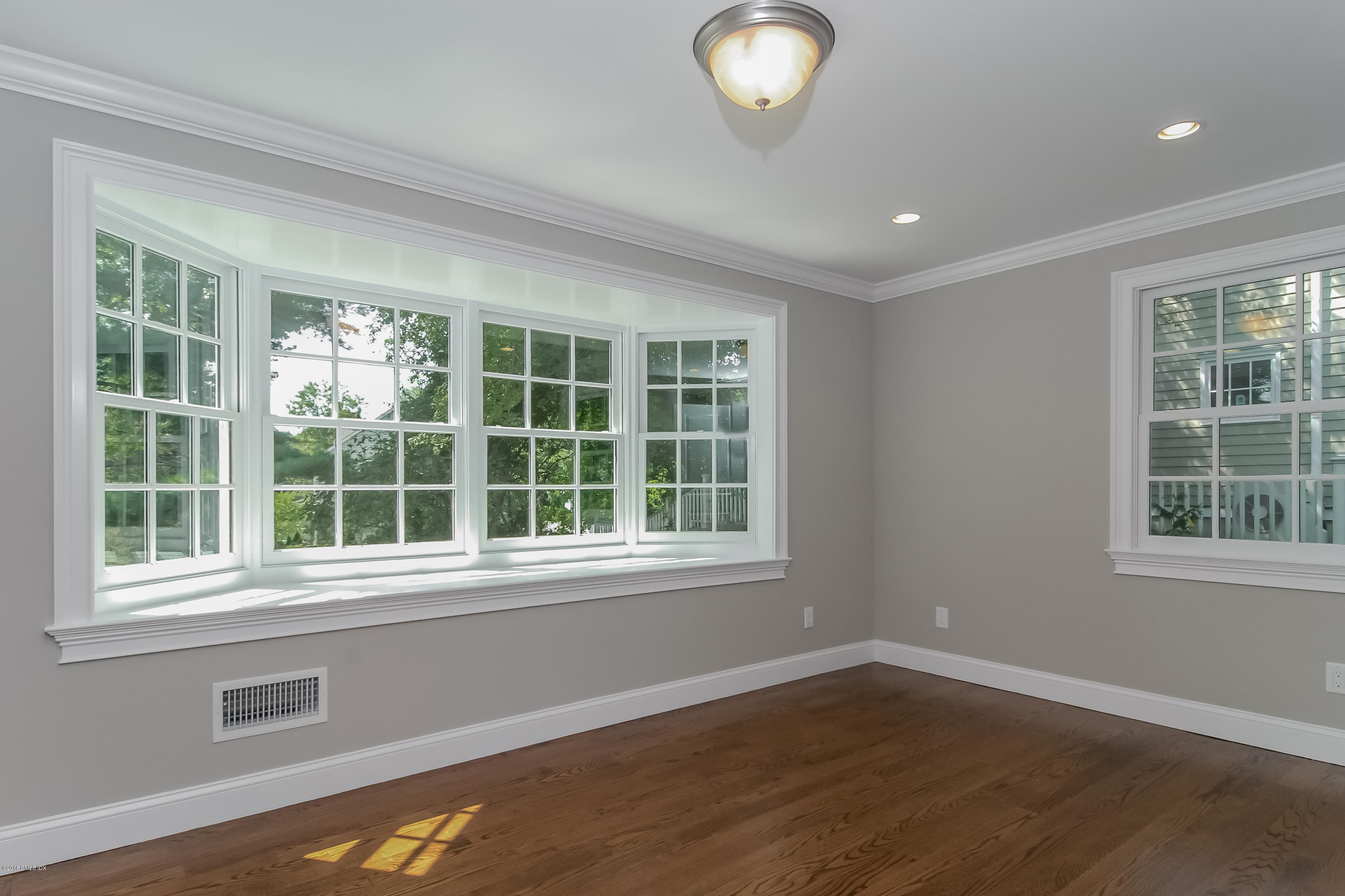 6 Dialstone Lane Riverside, CT 06878 - Photo 9 of 24 an empty room with wooden floor and windows