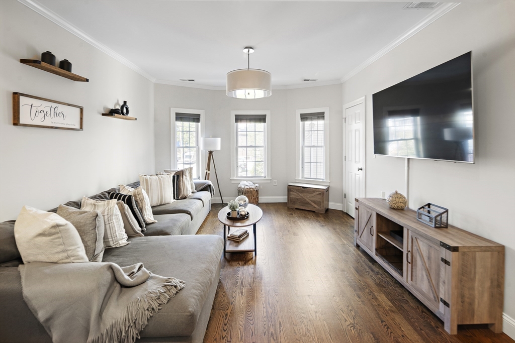 38 Pearl Street, Unit 2 Everett, MA 02149 - Photo 2 of 26 a living room with furniture and a flat screen tv