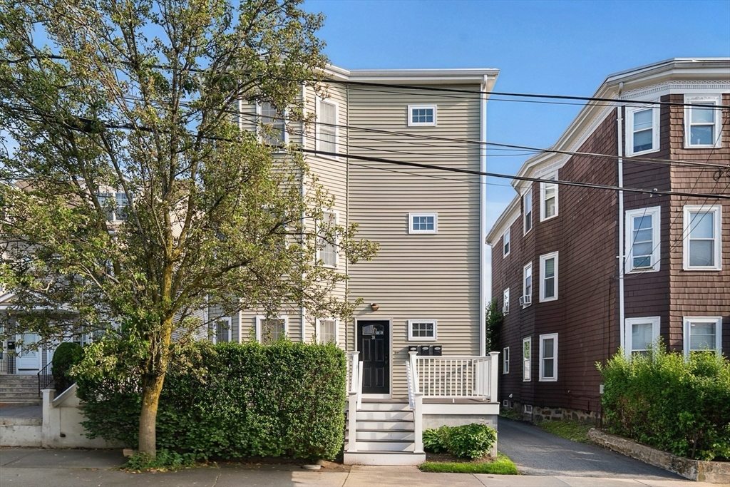 38 Pearl Street, Unit 2 Everett, MA 02149 - Photo 25 of 26 a front view of a house with plants