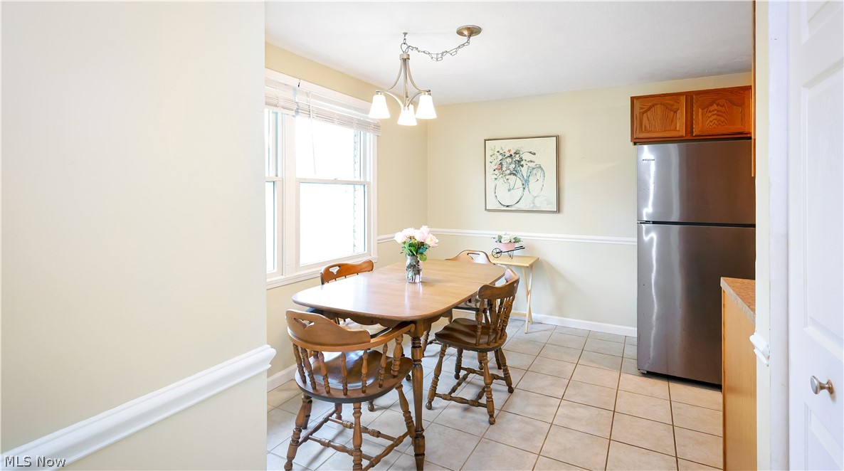 834 Wadsworth Road, Unit B1 Medina, OH 44256 - Photo 3 of 23 Tiled dining room with a chandelier