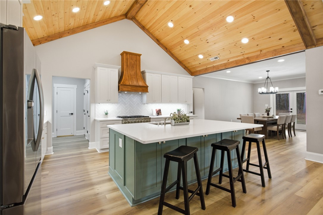 147 McAlister Road West Union, SC 29696 - Photo 8 of 49 This inviting kitchen with a vaulted ceiling and exposed beams connects seamlessly to the dining area.
