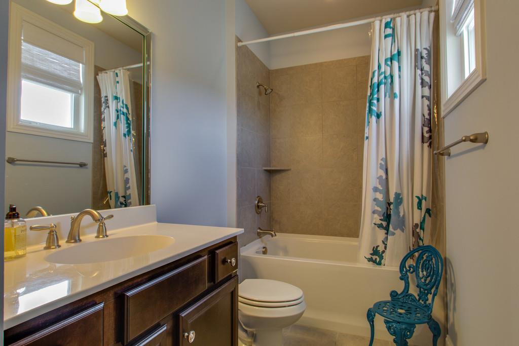 1409 Eliot Road Franklin, TN 37064 - Photo 16 of 27 a bathroom with a sink a toilet a mirror and shower