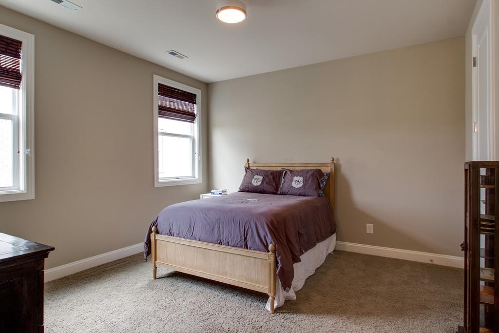 1409 Eliot Road Franklin, TN 37064 - Photo 17 of 27 a bed sitting in a bedroom next to a window