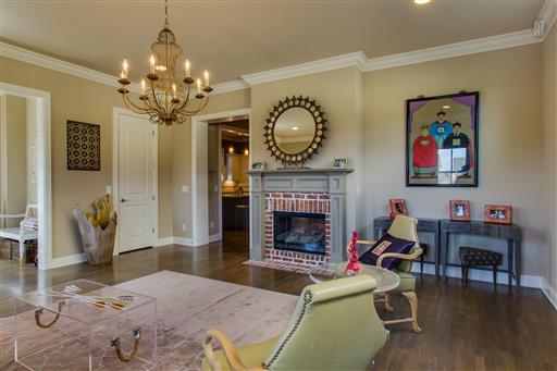 1409 Eliot Road Franklin, TN 37064 - Photo 4 of 27 a living room with furniture a chandelier and a fireplace