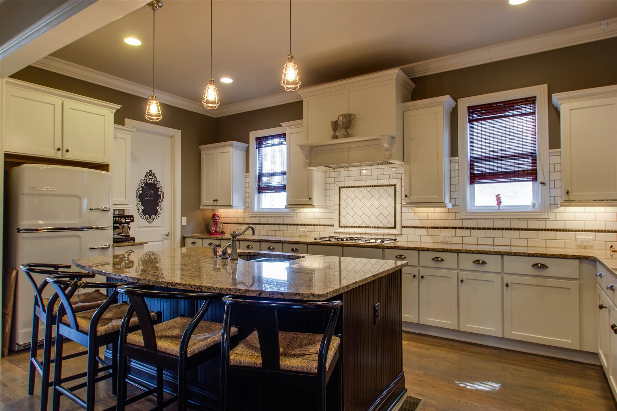 1409 Eliot Road Franklin, TN 37064 - Photo 6 of 27 a kitchen with a dining table chairs cabinets and stainless steel appliances
