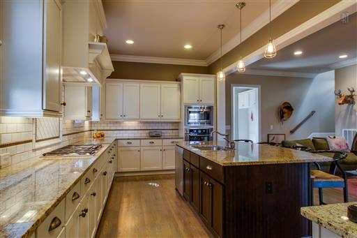 1409 Eliot Road Franklin, TN 37064 - Photo 7 of 27 a kitchen with granite countertop a sink stove and cabinets