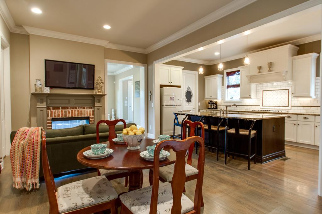 1409 Eliot Road Franklin, TN 37064 - Photo 8 of 27 a living room with furniture a flat screen tv and kitchen view