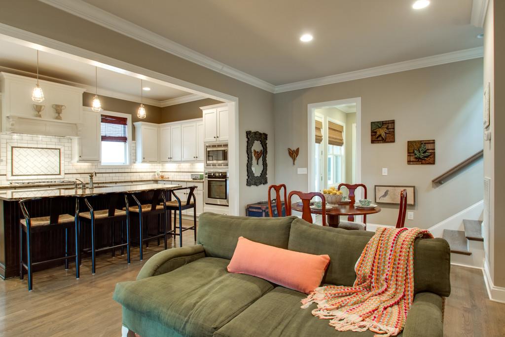 1409 Eliot Road Franklin, TN 37064 - Photo 9 of 27 a living room with furniture a wooden floor and kitchen view