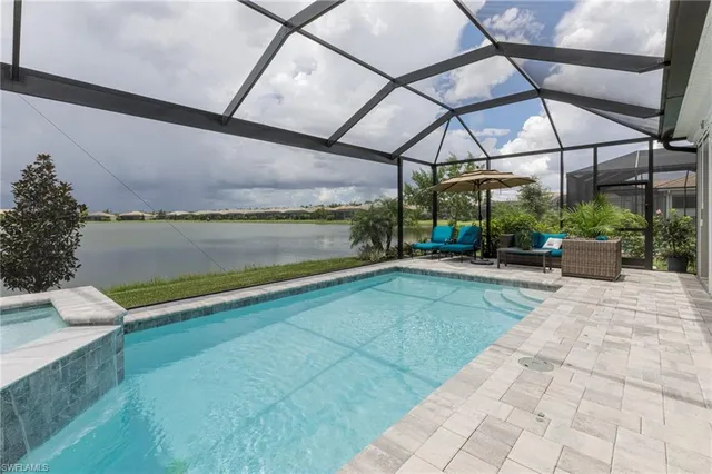 a view of a house with backyard porch and sitting area