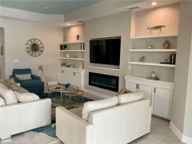 a kitchen with a dining table chairs wooden floor appliances and a counter top space