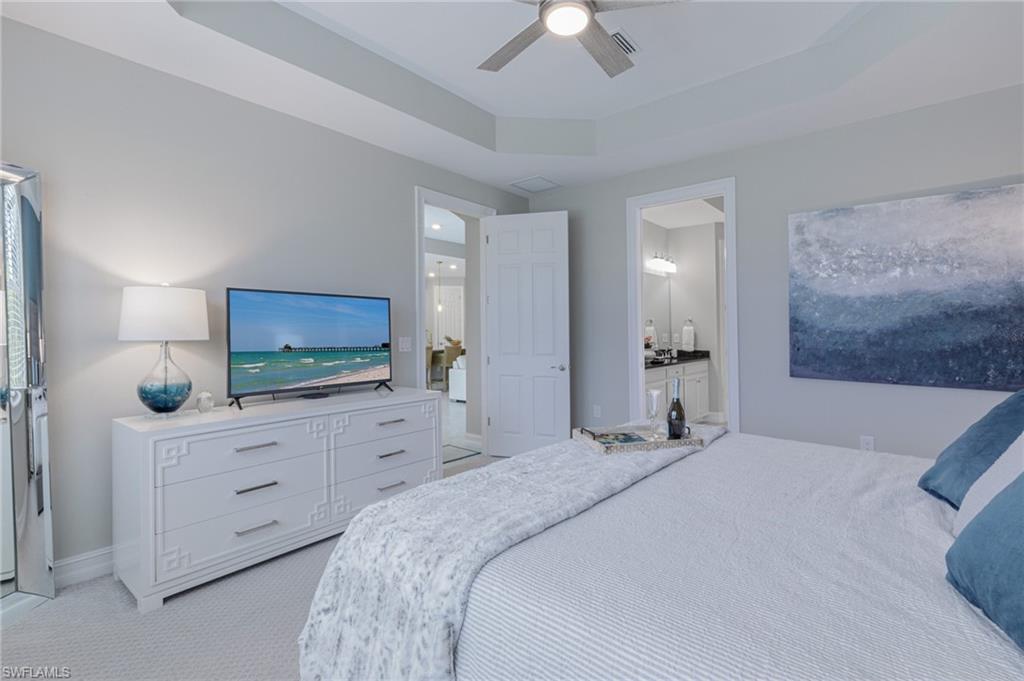 14614 Stillwater Way Naples, FL 34114 - Photo 19 of 47 a bedroom with a bed and a flat screen tv