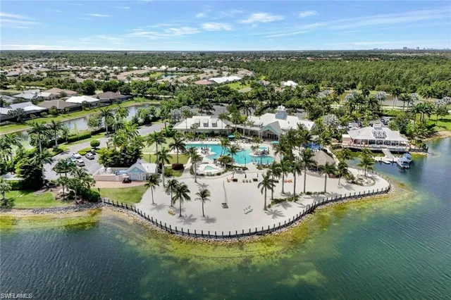 an aerial view of a house yard swimming pool and outdoor seating