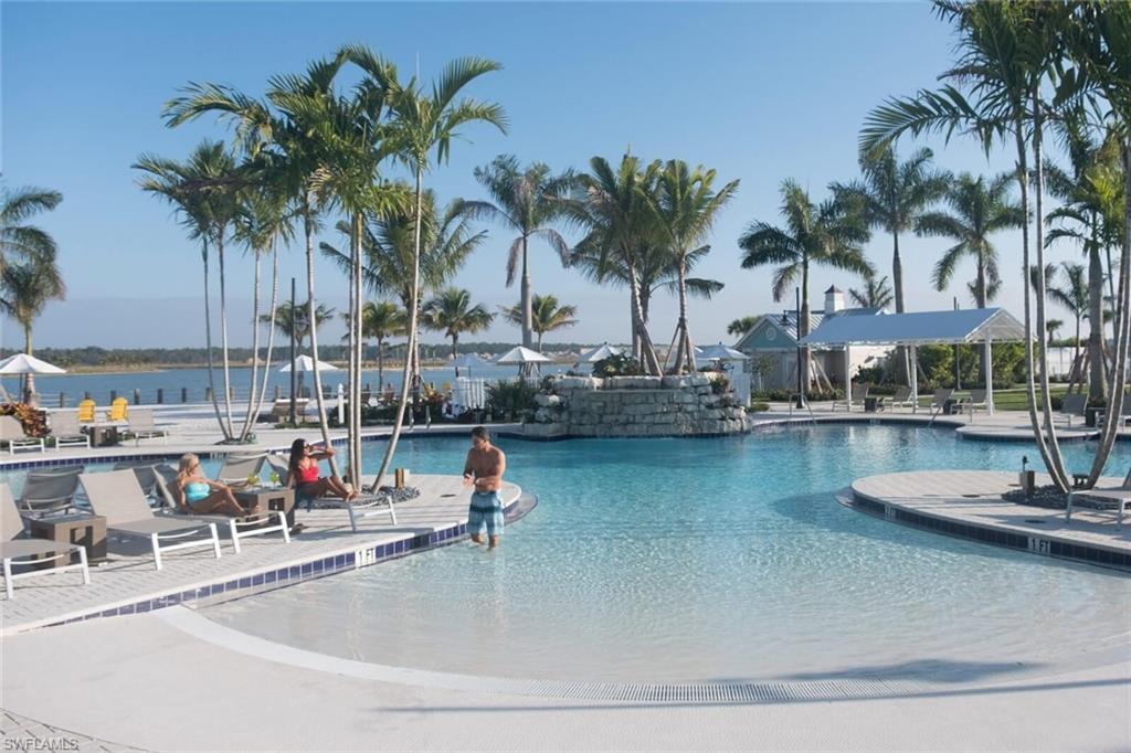 14614 Stillwater Way Naples, FL 34114 - Photo 39 of 47 a view of a swimming pool with a table and chairs