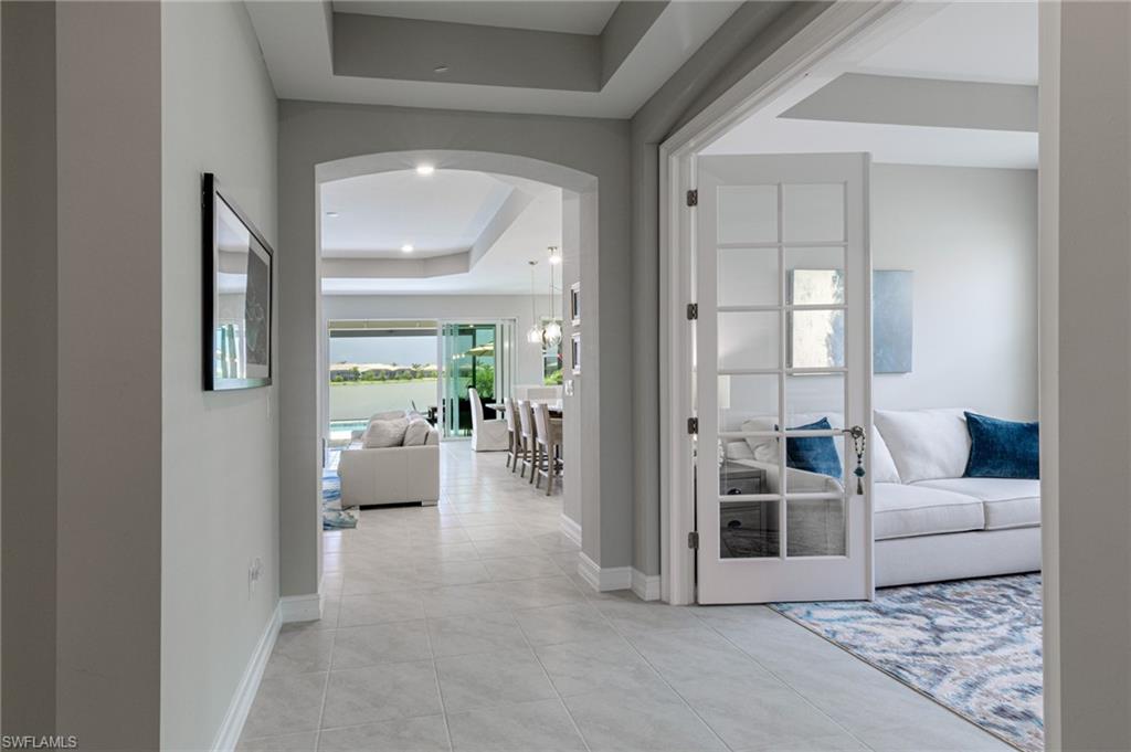 14614 Stillwater Way Naples, FL 34114 - Photo 4 of 47 a living room with furniture and a large window